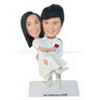 Groom in white suit holding his bride in wedding dress custom bobbleheads