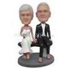 Groom in black suit and bride in white wedding dress sitting on the chair custom bobbleheads