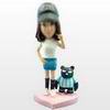 Casual female bobble head doll with a pet