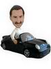 A man bobblehead with a black car