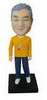 Male bobble head doll with  yellow T-shirt