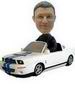 A man bobblehead with a white car