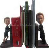 Book holder based on photos of couple bobble head dolls