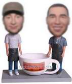 Two men with coffee cup bobble head dolls