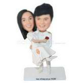 Groom in white suit holding his bride in wedding dress custom bobbleheads