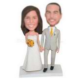 Groom in yellow tie and the bride holding a bunch of yellow flower custom bobbleheads