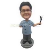 Male doctor holding up with a operating forceps custom bobbleheads 