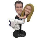 Groom in black suit holding bride in white wedding dress custom bobbleheads