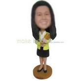 Female teacher in yellow coat matching with black dress holding book custom bobbleheads