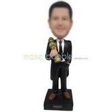 Cool man in black suit holding a sculpture custom bobbleheads