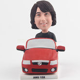 Handsome young man in a red car bobblehead