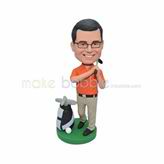 Orange shirt golf player bobble head doll