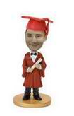 Bobble head doll with red graduation clothing