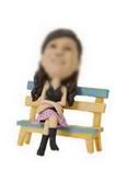 Fashion girl bobble head doll sitting in a chair