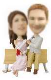 Weddings  bobblehead sitting on a bench