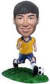 Playing football bobble head doll on the grass