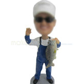 Man with fish bobble head doll