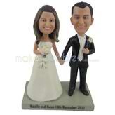 The bride and groom hold hands custom bobbleheads
