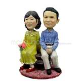 The couple are sitting on the benchcustom bobbleheads