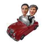 Custom couple bobbleheads  sit in the car