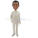 The groom wears a white suit custom bobbleheads