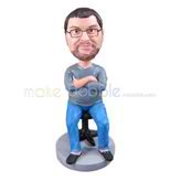 The man sits in a chair custom bobbleheads