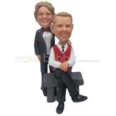 The man sits on a stone bench and his wife custom bobbleheads