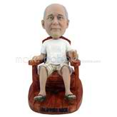 The man sits on a wooden chair custom bobbleheads