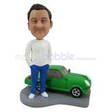 Custom man bobbleheads stands behind the car