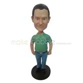 The man wears a green T'shirt custom bobbleheads