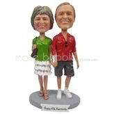 The woman carries a bag and her husband custom bobbleheads