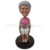 The woman sits on a chair custom bobbleheads