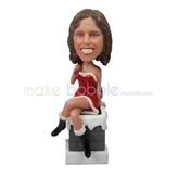 The woman sits on a stone bench custom bobbleheads