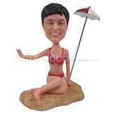 The woman sits on the beach custom bobbleheads