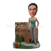 Custom female bobbleheads stands in the garden