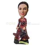 The woman wears a cheongsam custom bobbleheads