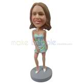 The woman wears a dress custom bobbleheads