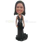 The woman wears a dress custom bobbleheads