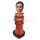 The woman wears the queen clothing custom bobbleheads