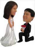 The bridegroom bobble head doll single knee down on their knees to marry him